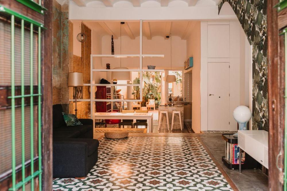 a living room with a couch and a table at La Casona Beach House in Valencia