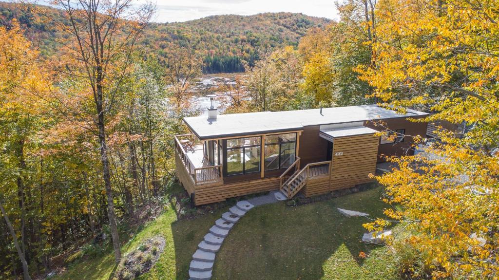 an aerial view of a tiny house in the woods at Modern Chalet with Mountain and Lake view by Reserver.ca in Sainte-Adèle