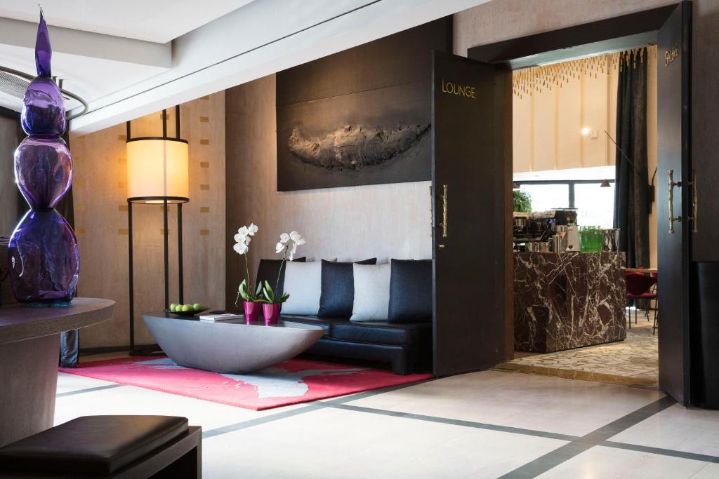 a living room with a couch and a table at Hotel Square in Paris