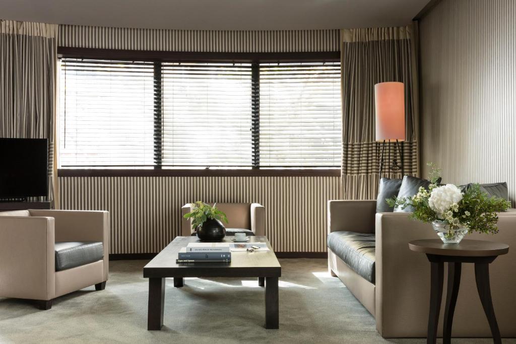 a living room with a couch and a coffee table at Hotel Square in Paris