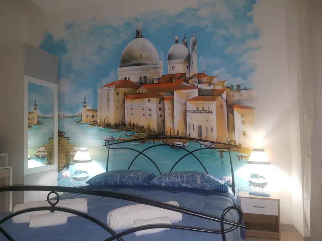 a bedroom with a castle mural on the wall at Bed Rho Stazione in Rho