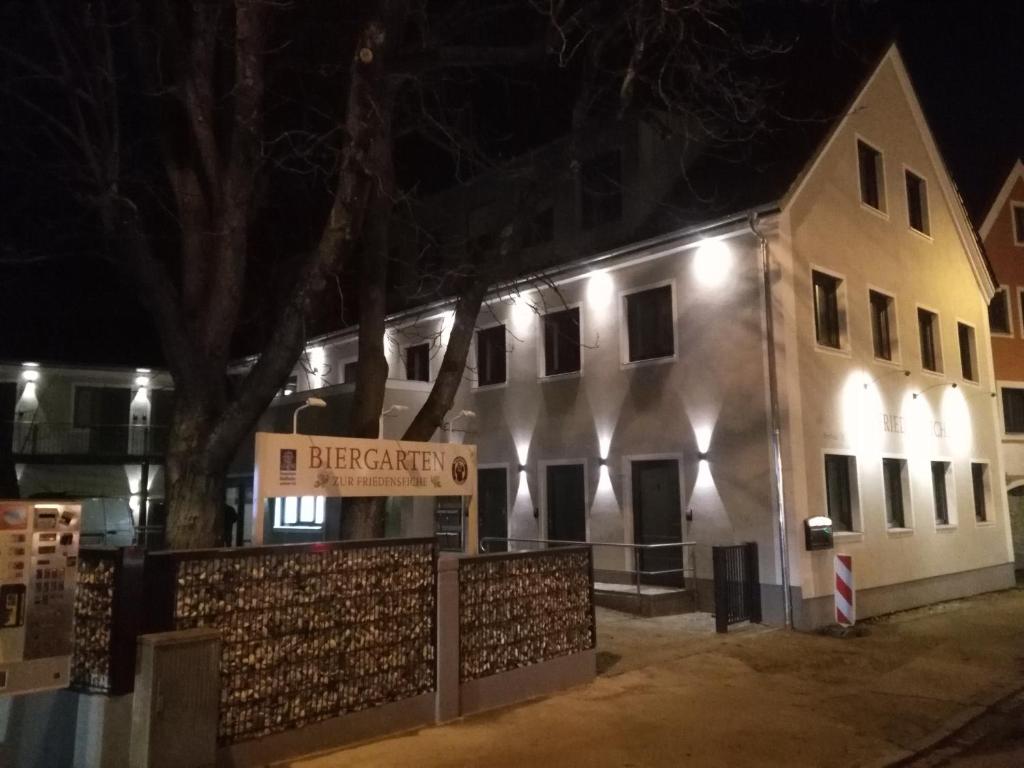 a white building with a sign in front of it at Zur Friedenseiche in Aichach