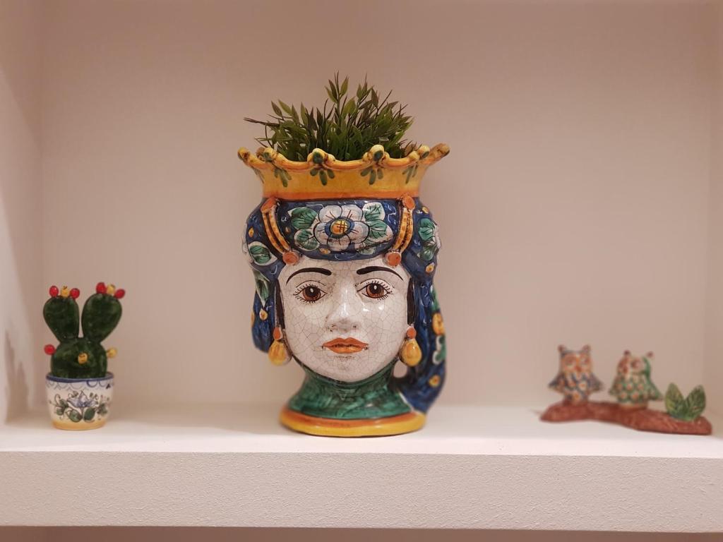 a vase with a face with a crown on it at Sicily Luxury B&B in Catania