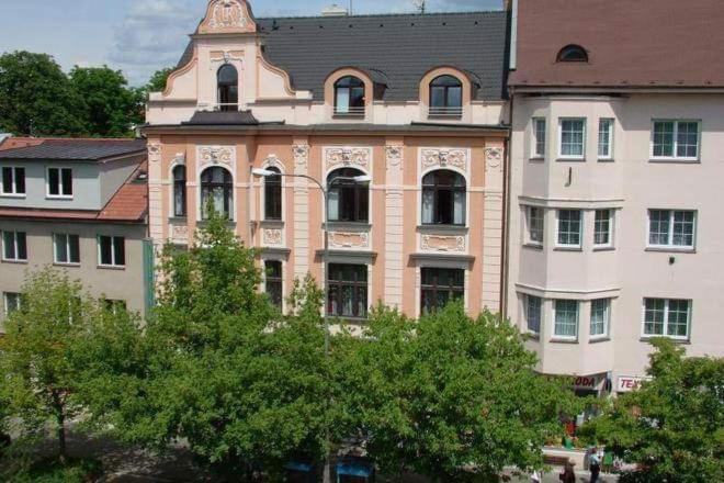 a large building with a tower on top of it at Penzion Lara in České Budějovice