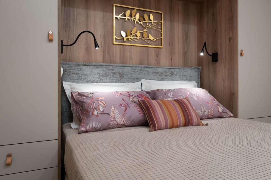 a bedroom with a bed with pink pillows at Absolute Athens v in Athens