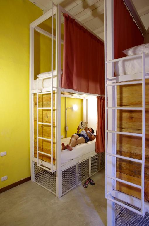 a person laying on a bed in a room with bunk beds at Casa Tunido in Santa Marta