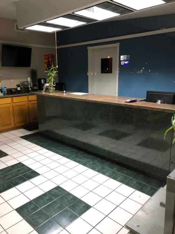 a large kitchen with a counter in a room at Delux Inn Cleburne in Cleburne