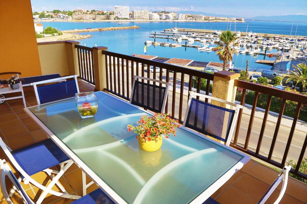 uma varanda com uma mesa e vista para um porto em Apartment Colette em L'Escala