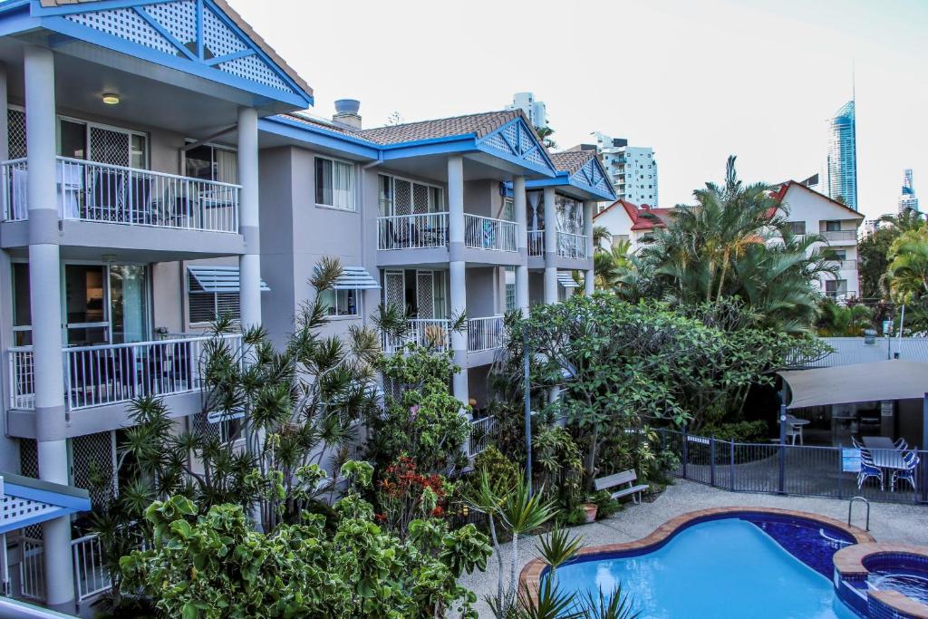 an aerial view of a building with a pool and trees at Surfers Beach Holiday Apartments in Gold Coast