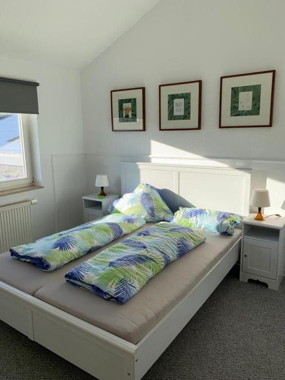 a bed with two pillows on it in a bedroom at Ferienwohnung Blütenstadt in Leichlingen