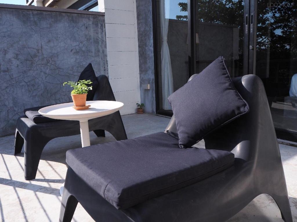 a chair and a table on a patio at Samatha Bed & Breakfast in Ko Tao