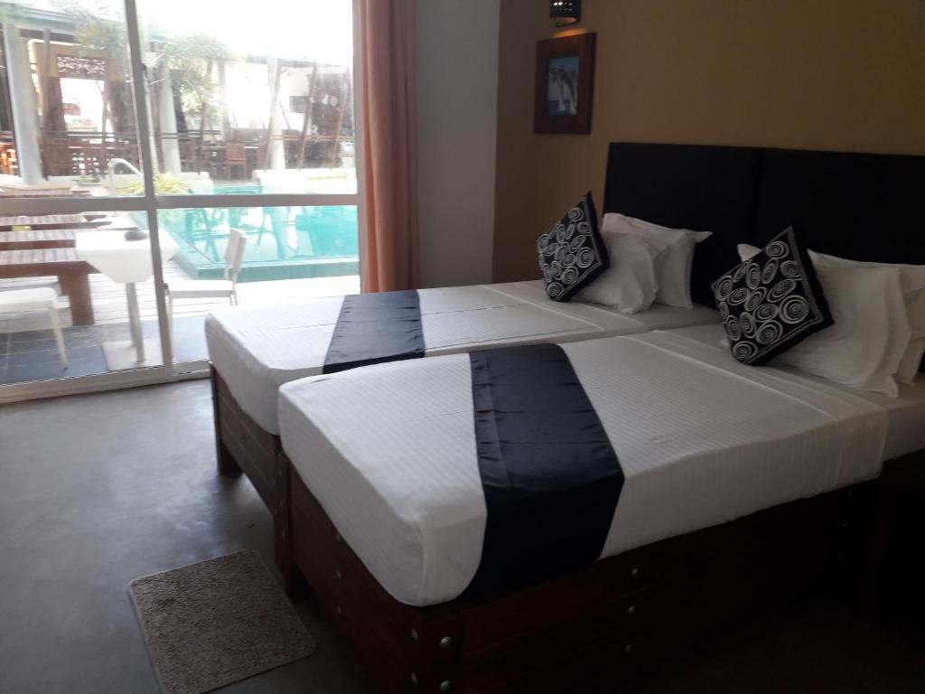 Postel nebo postele na pokoji v ubytování Nil Diya Beach Resort