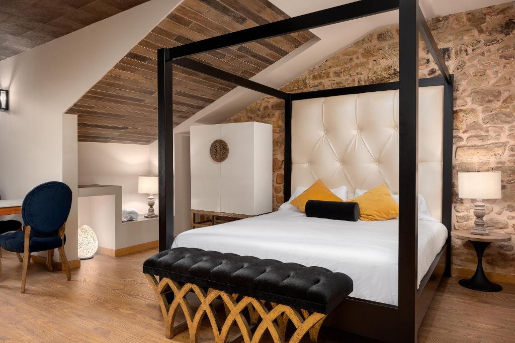 a bedroom with a large bed with a black frame at SUITE 1907 AVILES in Avilés