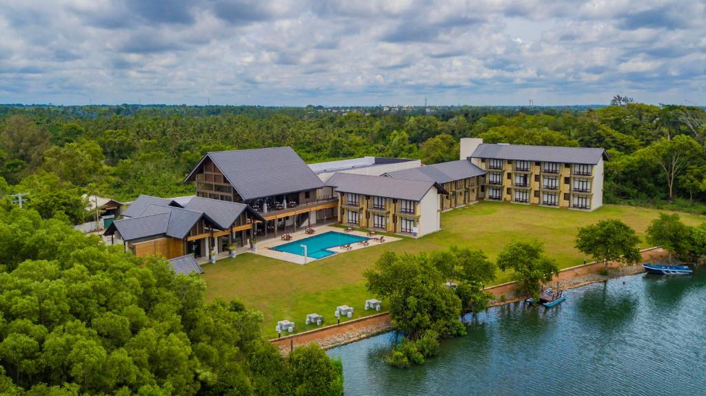 an aerial view of a large house on the water at Amora Lagoon Hotel in Katunayake