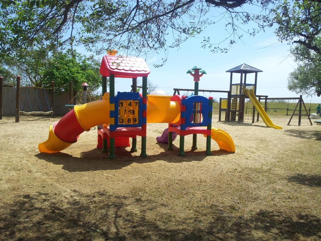 a playground with a slide and a slideintend at Hotel Valdor in Cavallino-Treporti