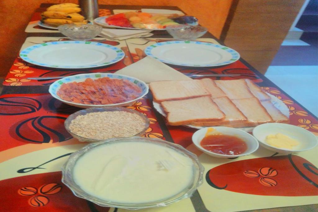 a table topped with plates and bowls of food at Landy Queen in Munnar