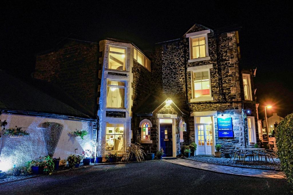 a large stone house at night with lights at Sunnyside Guest House in Keswick