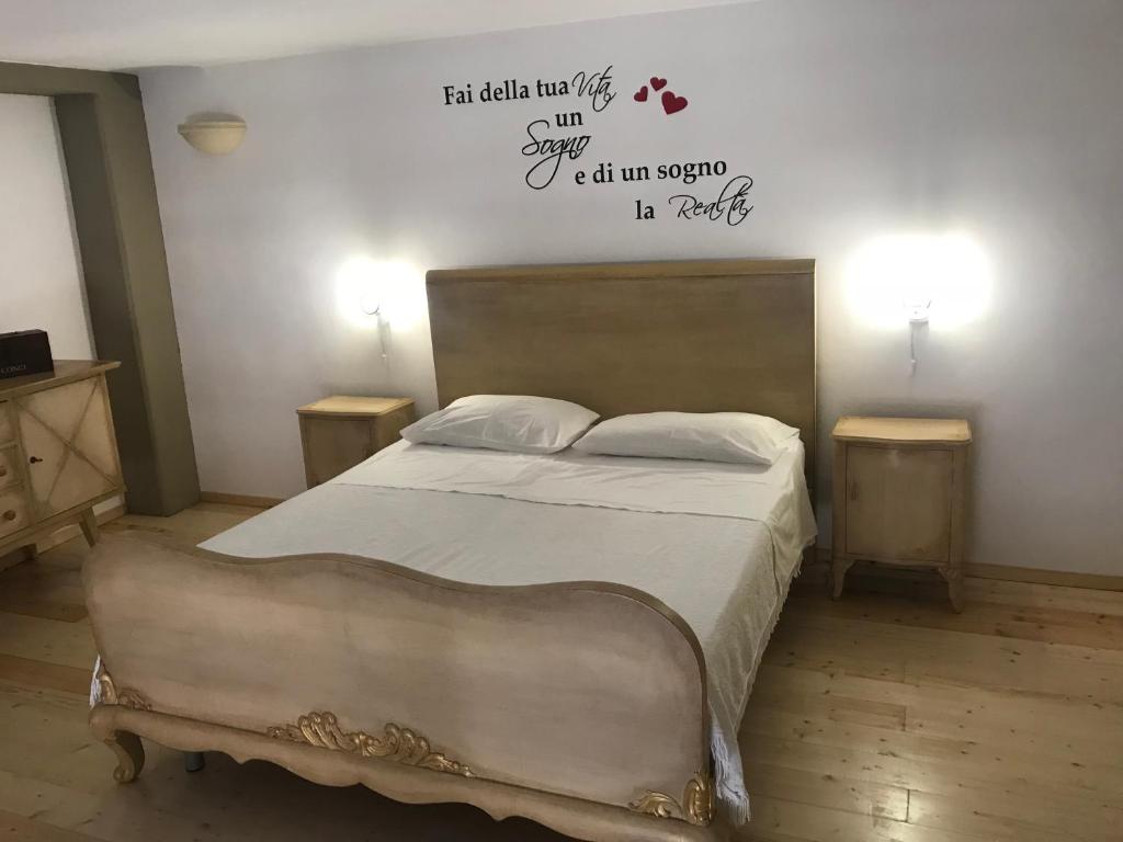 um quarto com uma cama com palavras na parede em Greta Viola House em Squinzano
