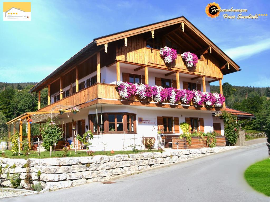 a building with flower boxes on the side of it at Haus Sonnbichl in Schliersee