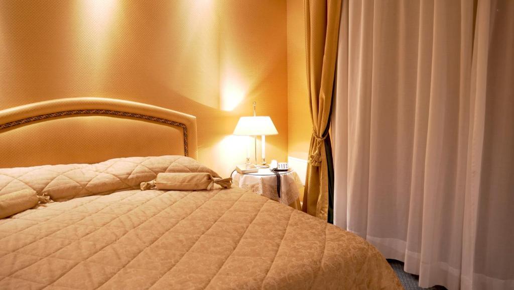 Postel nebo postele na pokoji v ubytování 501 Hotel