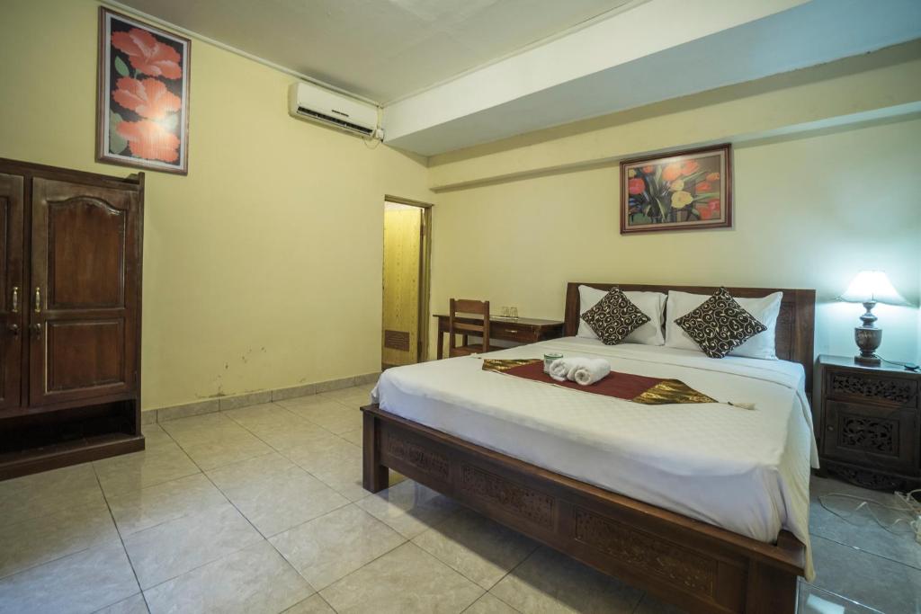 Postel nebo postele na pokoji v ubytování Tegar Guest House Ubud