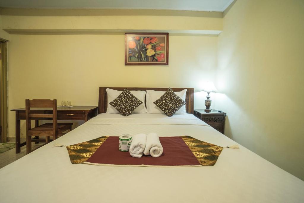 Postel nebo postele na pokoji v ubytování Tegar Guest House Ubud
