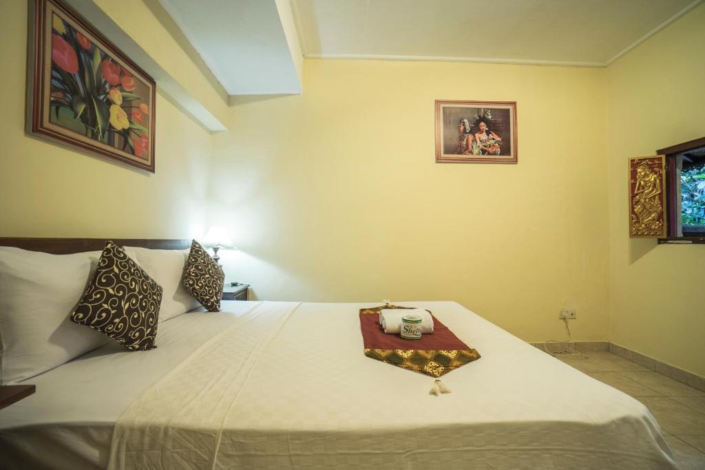 Postel nebo postele na pokoji v ubytování Tegar Guest House Ubud