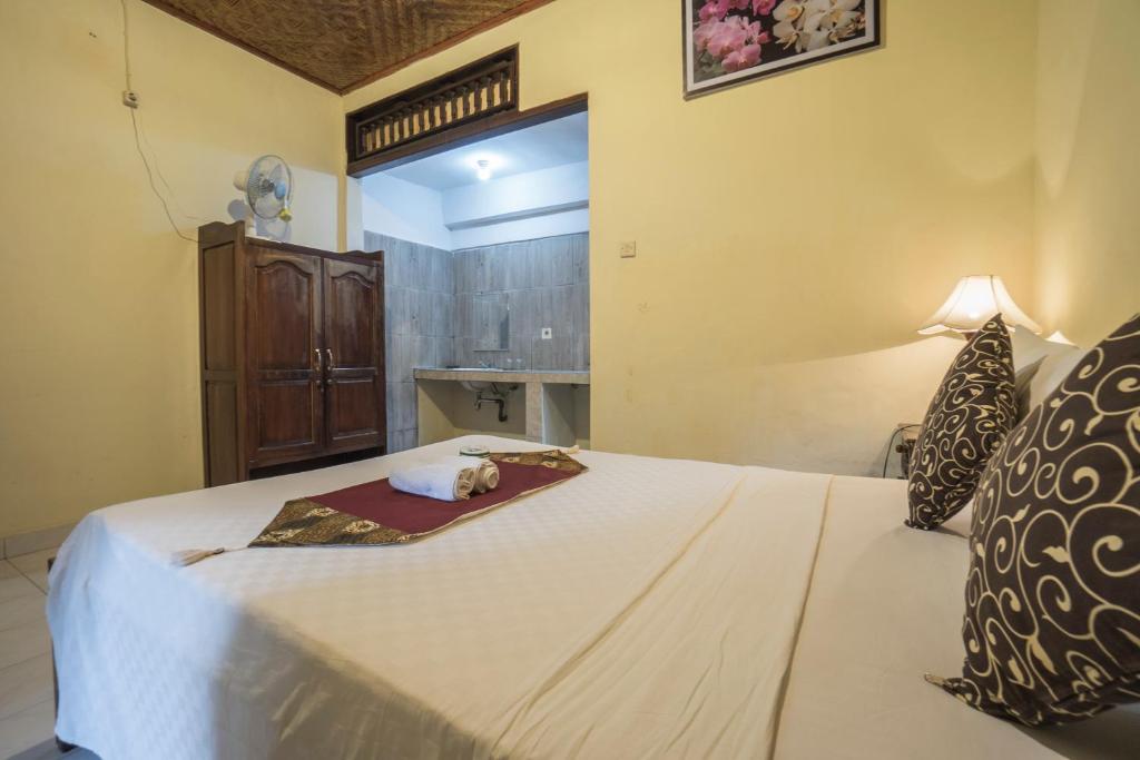 Postel nebo postele na pokoji v ubytování Tegar Guest House Ubud