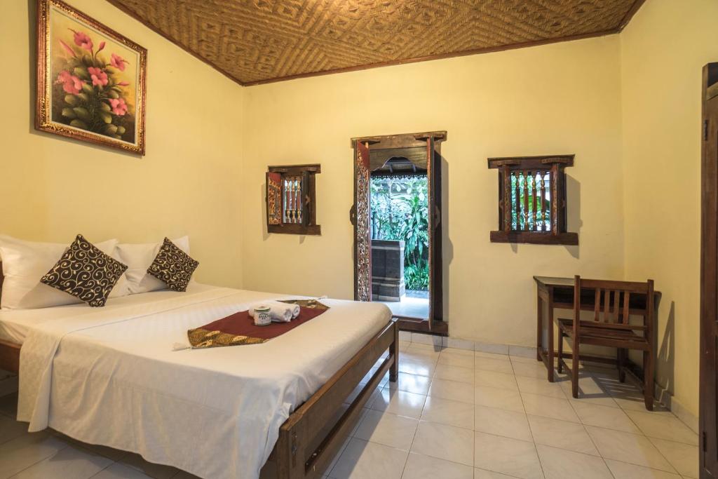 Postel nebo postele na pokoji v ubytování Tegar Guest House Ubud