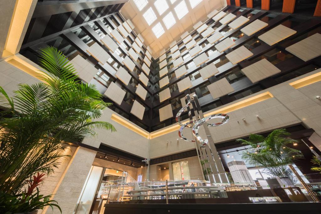 a large building with a ceiling with plants at Hotel Metropolitan Tokyo Marunouchi in Tokyo