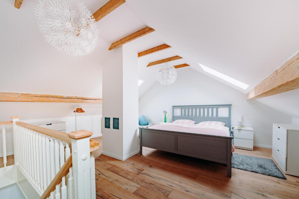 a bedroom with a bed and a staircase at Harzallerliebst in Braunlage