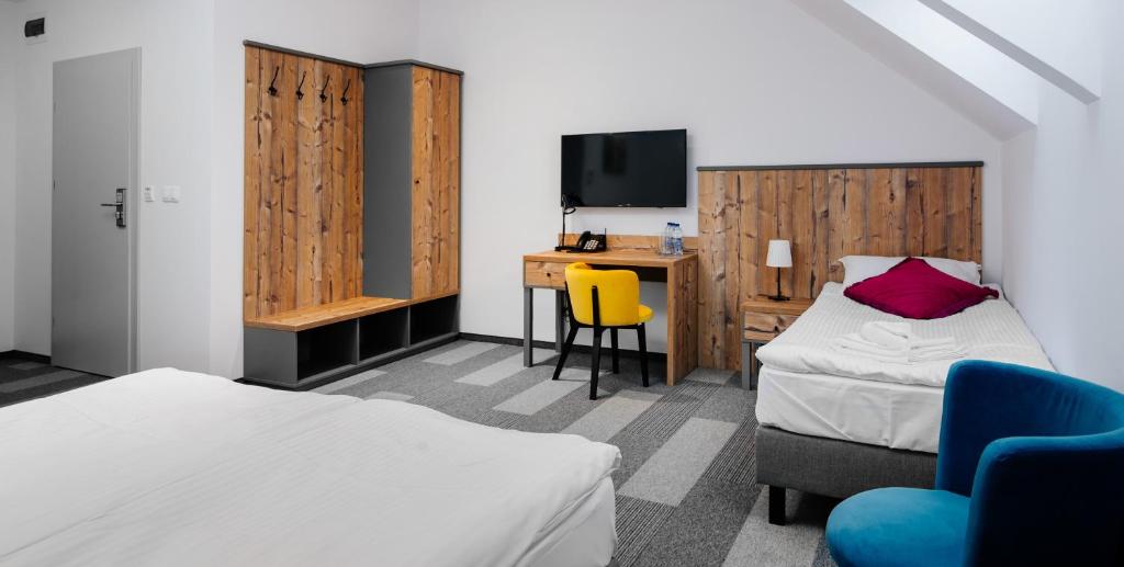 Postel nebo postele na pokoji v ubytování Hotel Nowa Holandia