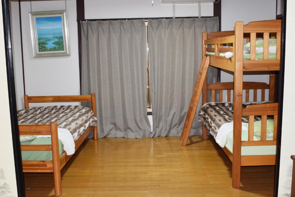 Postel nebo postele na pokoji v ubytování Share House Amigos