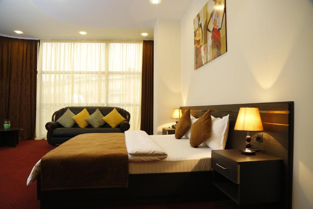 Postel nebo postele na pokoji v ubytování Tomu's Hotel