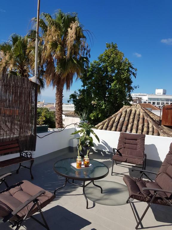 
a patio area with chairs, tables and umbrellas at Faro Town House in Faro
