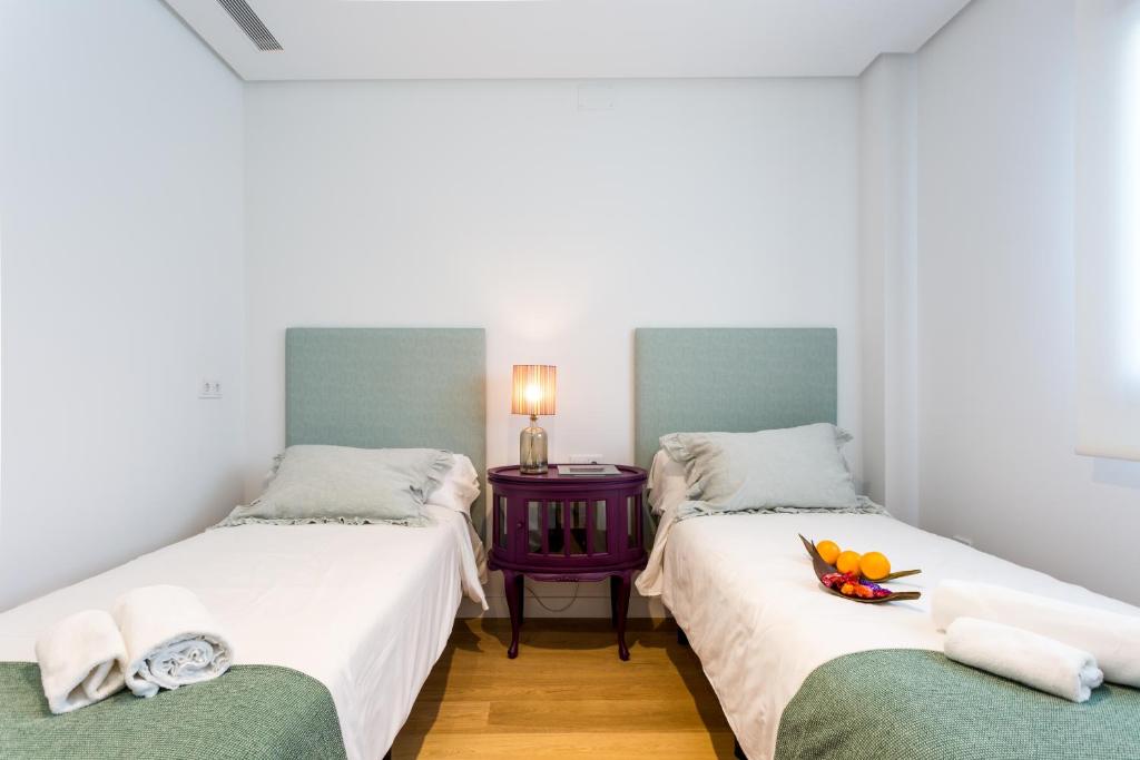 Postel nebo postele na pokoji v ubytování Apartamentos RG Plaza de España