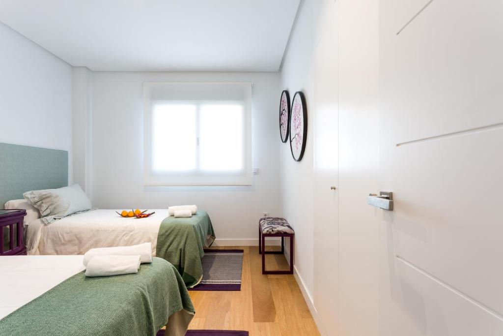 Postel nebo postele na pokoji v ubytování Apartamentos RG Plaza de España