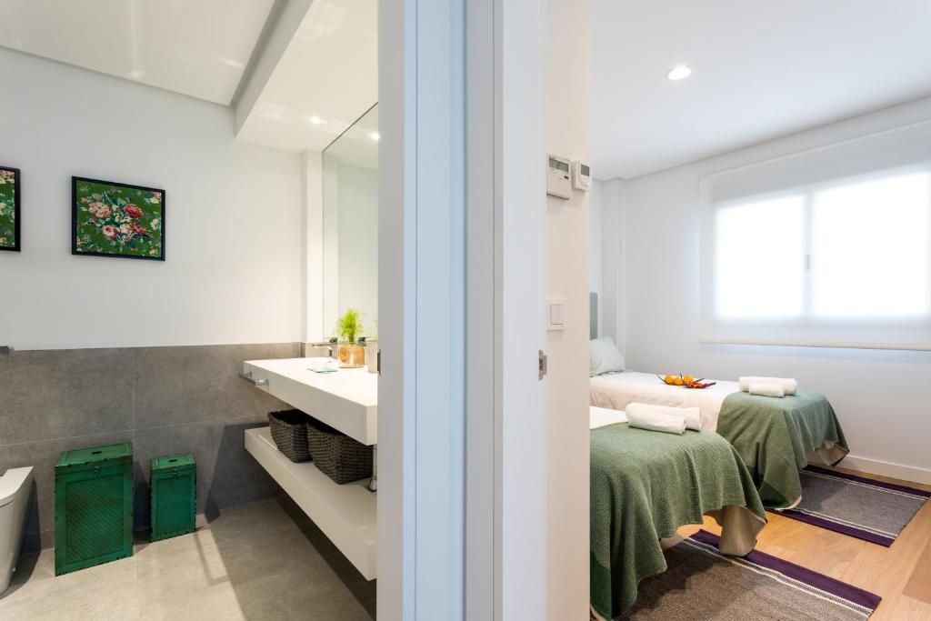 Postel nebo postele na pokoji v ubytování Apartamentos RG Plaza de España