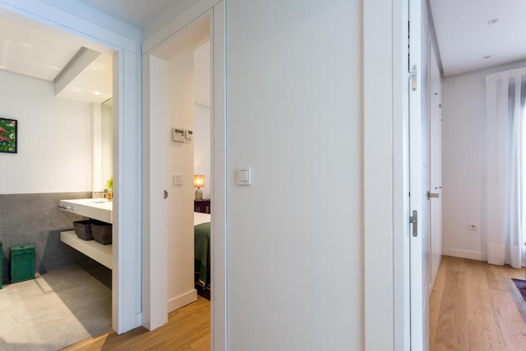 Postel nebo postele na pokoji v ubytování Apartamentos RG Plaza de España