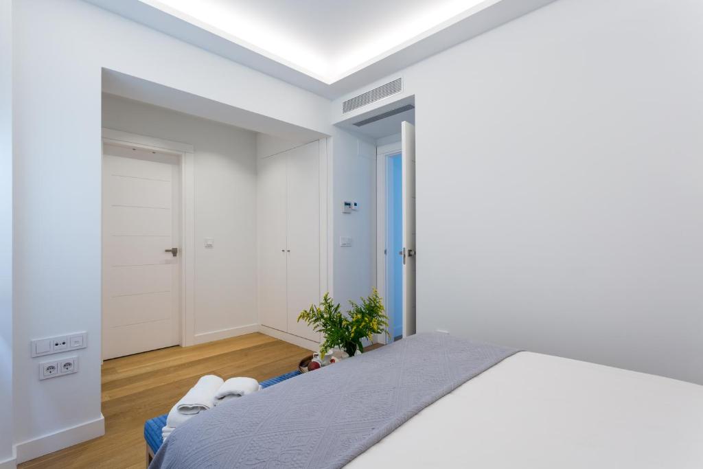 Postel nebo postele na pokoji v ubytování Apartamentos RG Plaza de España