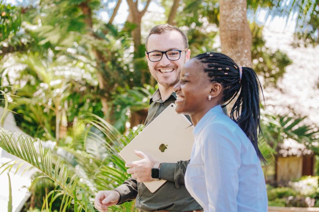 a man and a woman standing next to each other at Tulia Zanzibar Unique Beach Resort in Pongwe