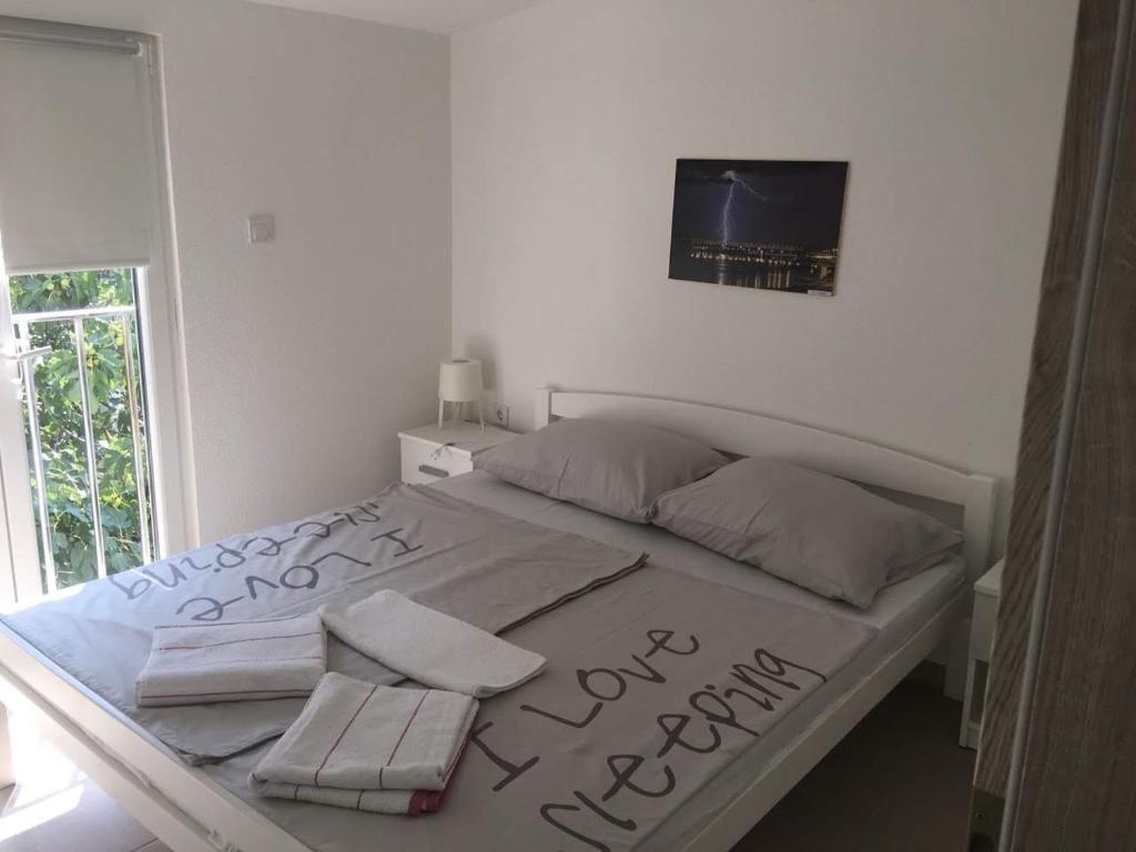 Posteľ alebo postele v izbe v ubytovaní Apartman Bunarić