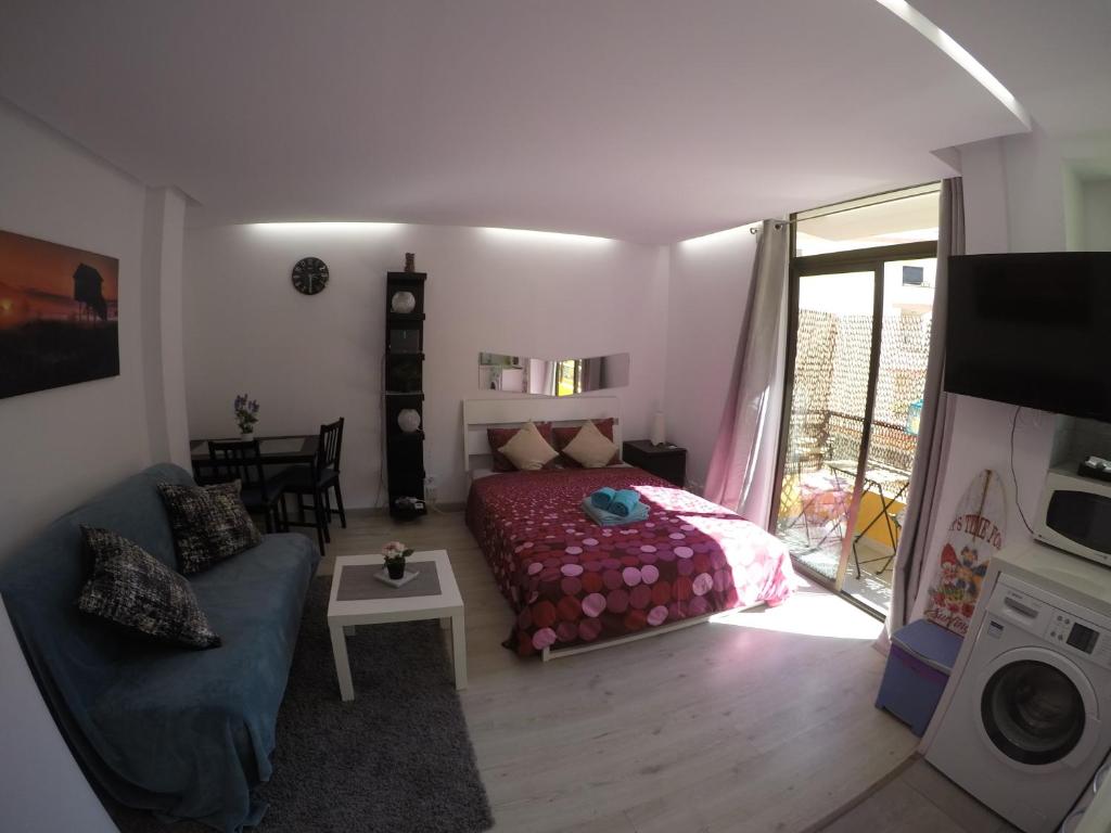 ラスパルマス・デ・グランカナリアにあるEstudio Moralesのベッドルーム(ベッド1台、ソファ、テレビ付)