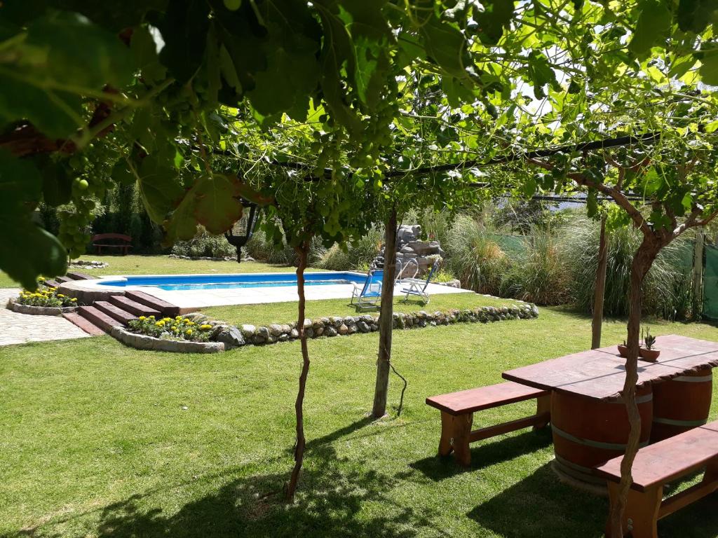 a park with a picnic table and a swimming pool at Balcones de San Carlos - casa Balcones in Cafayate