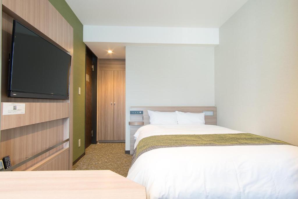 Postel nebo postele na pokoji v ubytování Fujinomiya Fujikyu Hotel