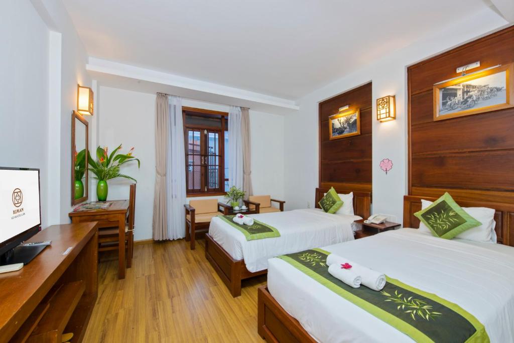 Postel nebo postele na pokoji v ubytování Kiman Hoi An Hotel