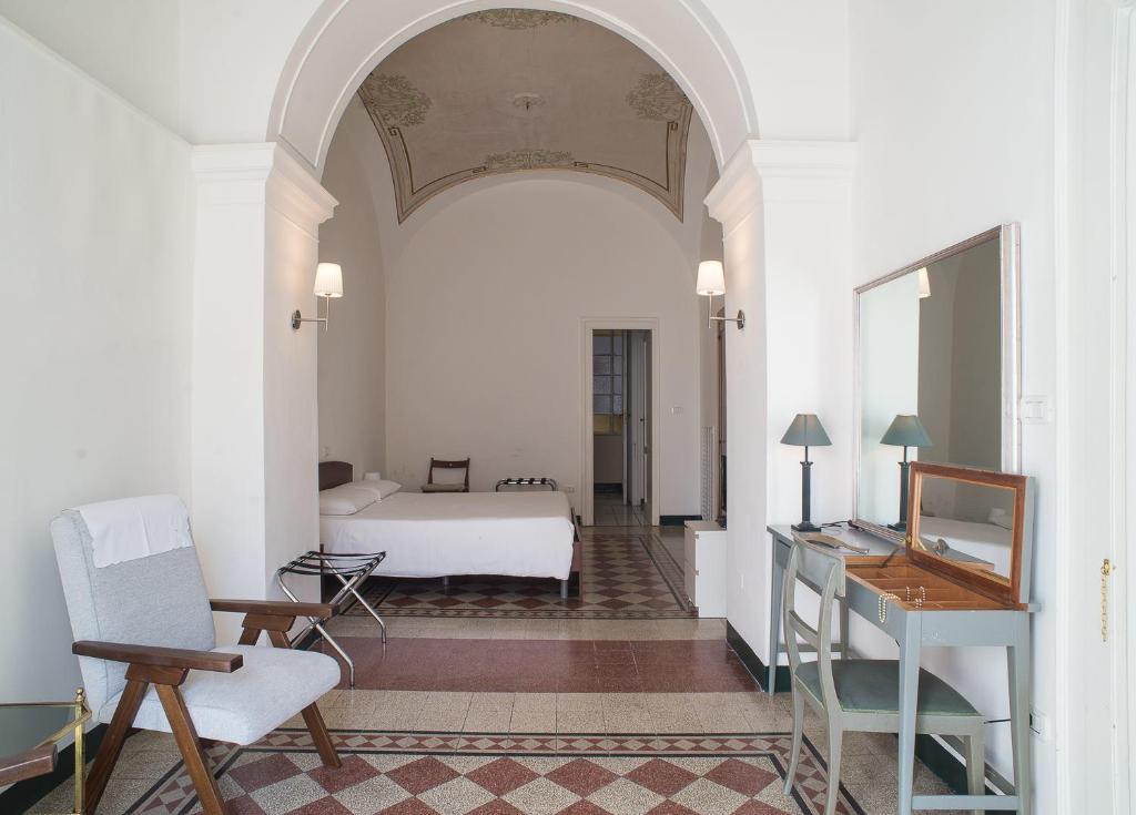 a bedroom with a bed and a table and a chair at Home47 in Salerno