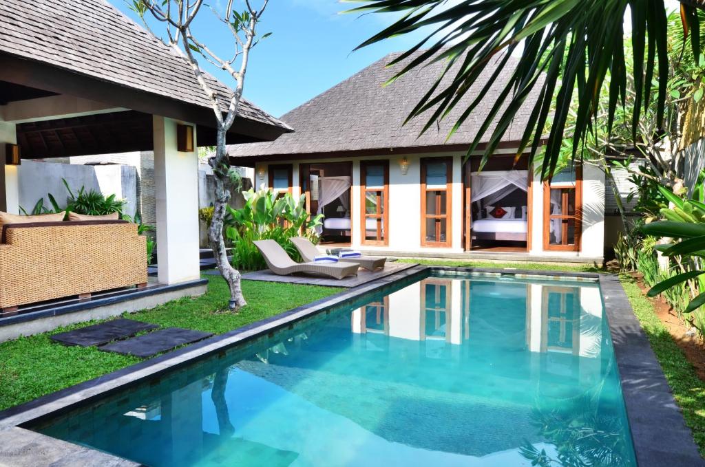 a swimming pool in front of a villa at The Khayangan Dreams Villa Umalas in Seminyak