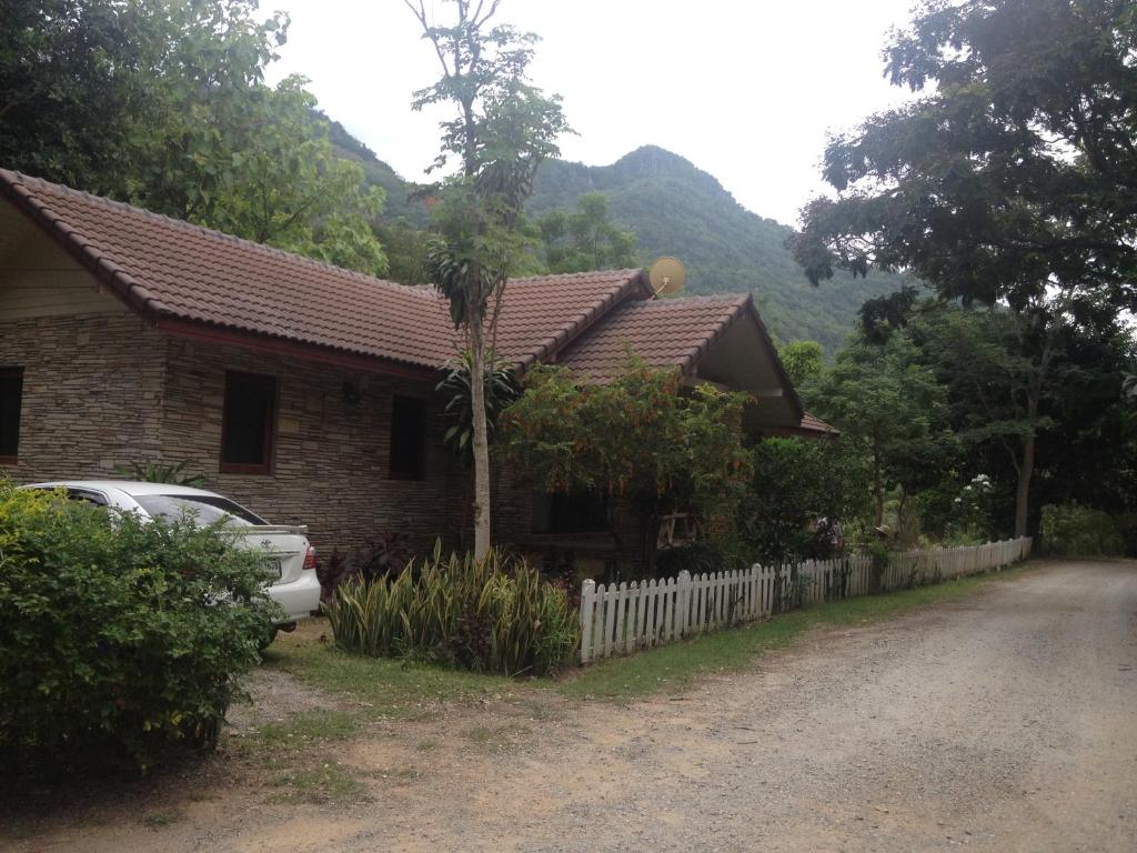 a house with a car parked in front of it at Klang Dong Mountain View - Khao Yai in Klang Dong