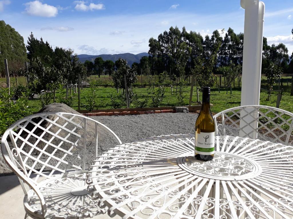 a bottle of wine sitting on a table at Woodside Orchard in Greytown